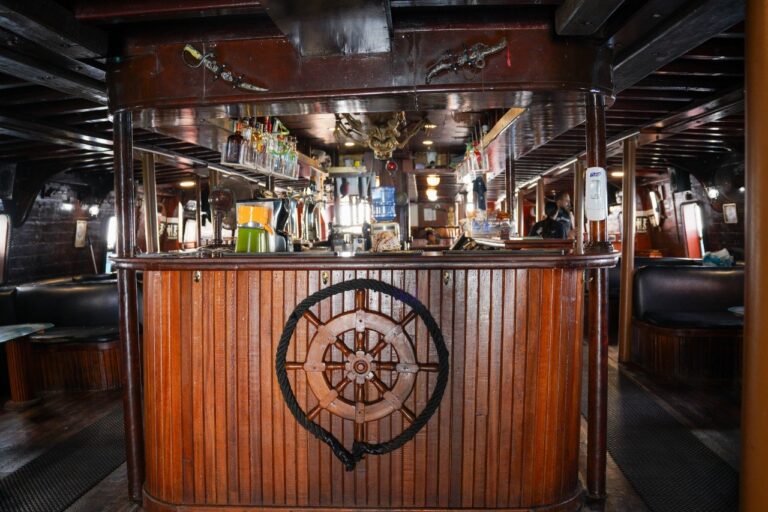 Inside of cozy ship-themed bar with wooden decor.