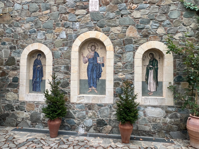 Stone wall with three religious mosaics.